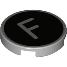 Part 14769pb427 - Tile, Round 2 x 2 with Bottom Stud Holder with Silver Capital Letter F on Black Background Pattern