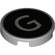 Part 14769pb428 - Tile, Round 2 x 2 with Bottom Stud Holder with Silver Capital Letter G on Black Background Pattern