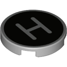 Part 14769pb429 - Tile, Round 2 x 2 with Bottom Stud Holder with Silver Capital Letter H on Black Background Pattern