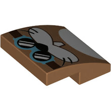 Part 15068pb405 - Slope, Curved 2 x 2 x 2/3 with Medium Azure Goggles with Dark Brown Strap, Black Nose and Whiskers, White Cheeks and Tooth Pattern (Super Mario Rocky Wrench Face)