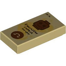 Part 3069pb1243 - Tile 1 x 2 with Reddish Brown Minifigure Head Skeleton and Circle with Omega Sign, Gold Swirl with Stars and Dark Brown Text Pattern (Dungeons & Dragons Spell Scroll of Speak with Dead)